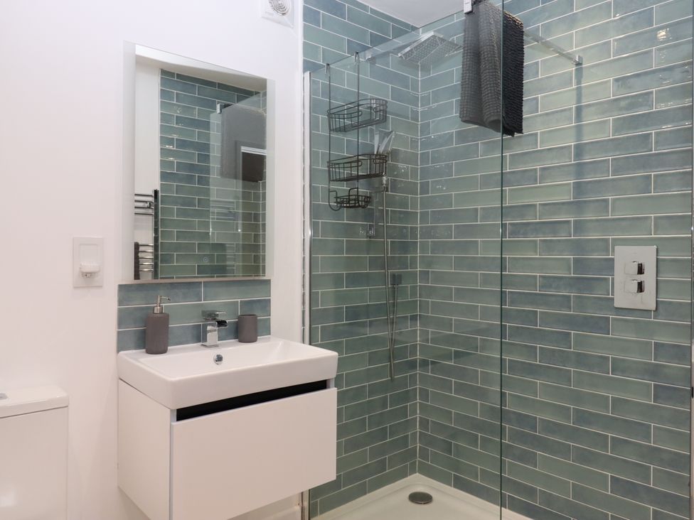 A bathroom with a sink, toilet, and shower at Lower Moorwood in Moorwood near Bovey Tracey