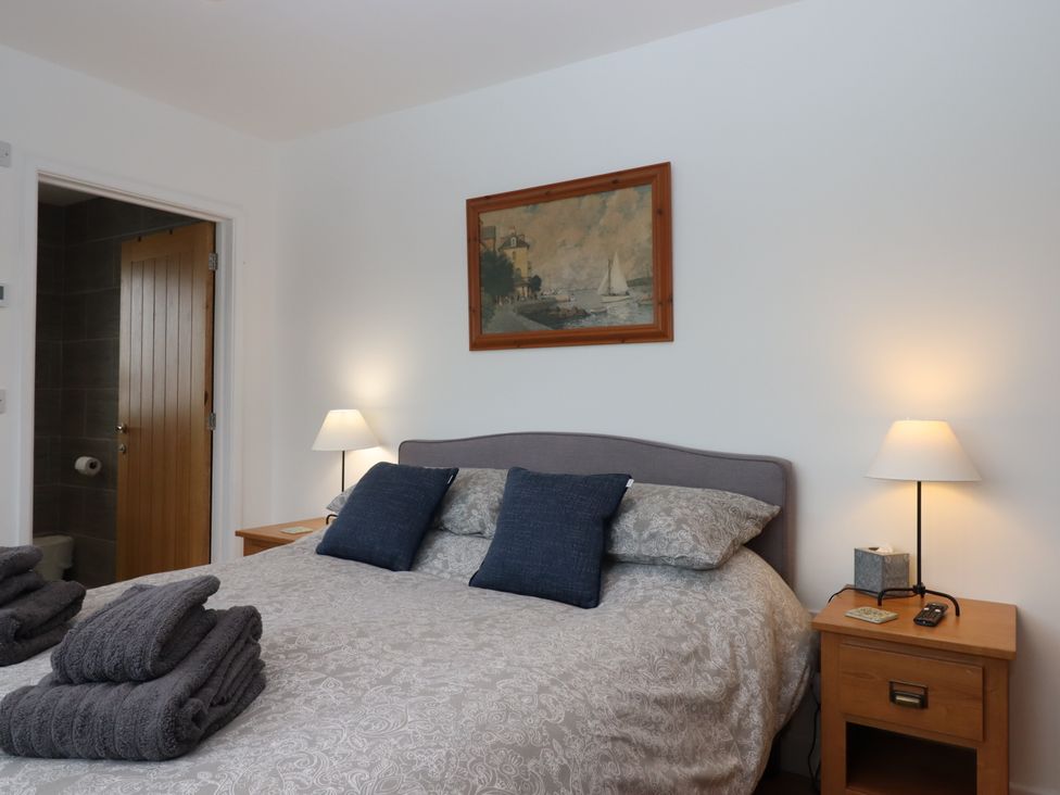 A bedroom with a bed and bedside table at Lower Moorwood Moorwood near Bovey Tracey