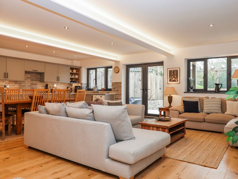 A living room with a kitchen area at Lower Moorwood in Moorwood near Bovey Tracey