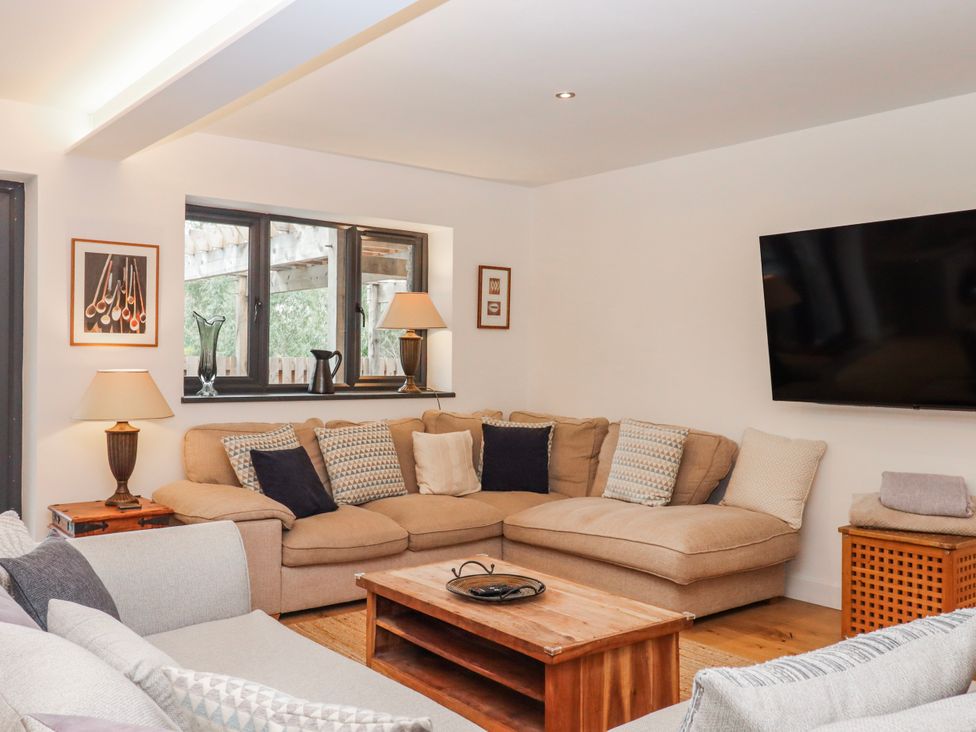 A living room with a sofa and coffee table at Lower Moorwood in Moorwood near Bovey Tracey