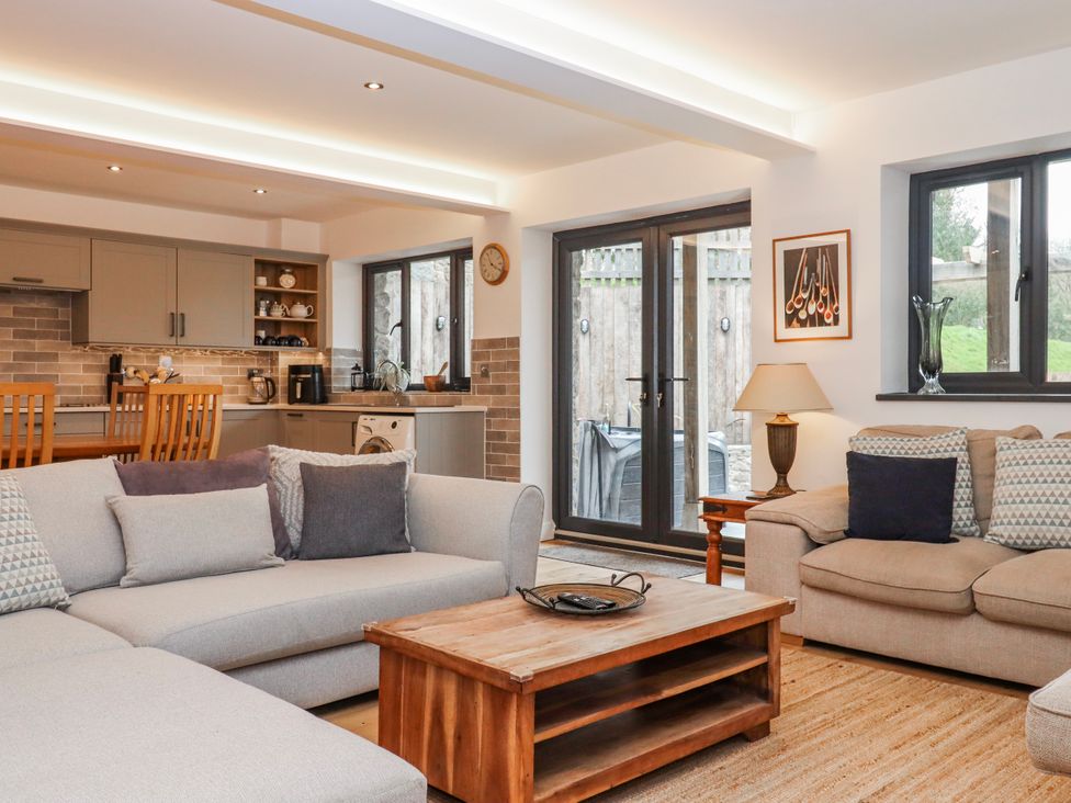 A living room with a sofa and coffee table at Lower Moorwood near Bovey Tracey
