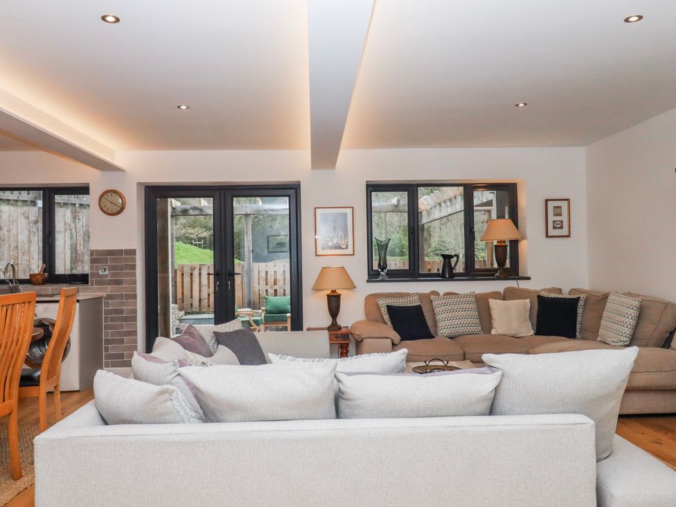 A living room with a sofa and armchair at Lower Moorwood near Bovey Tracey