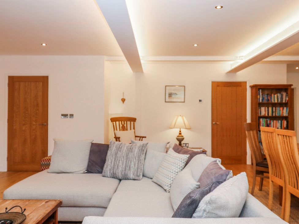 A living room with a sofa and lamp at Lower Moorwood near Bovey Tracey