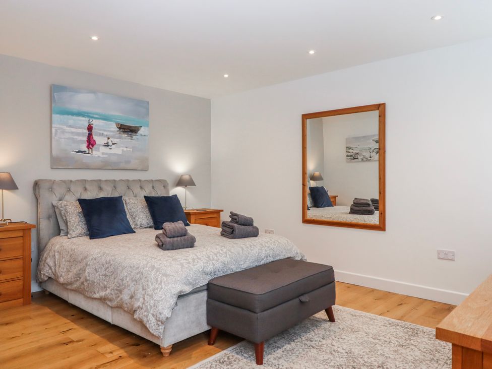 A bedroom with a bed and side tables at Lower Moorwood in Moorwood near Bovey Tracey