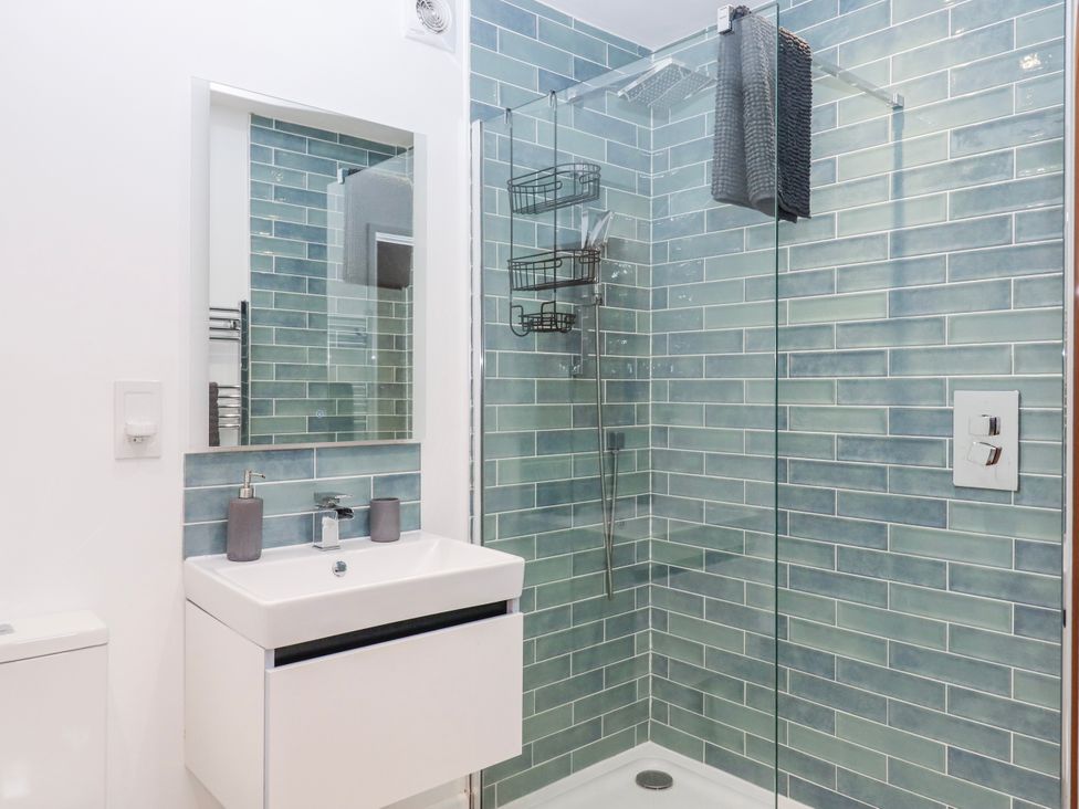 A bathroom with a shower and sink at Lower Moorwood, Moorwood near Bovey Tracey