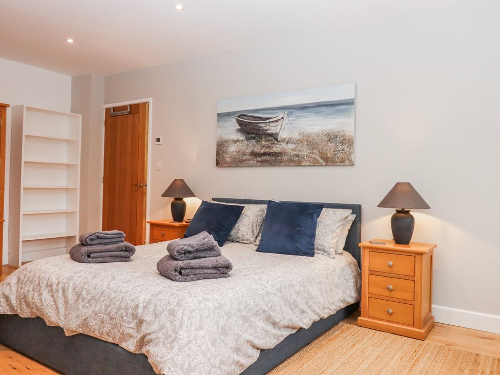 A bedroom with a bed and bedside tables at Lower Moorwood in Moorwood near Bovey Tracey