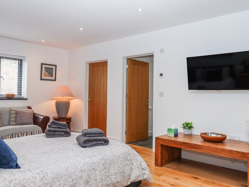 A bedroom with a bed and a television at Lower Moorwood in Moorwood near Bovey Tracey