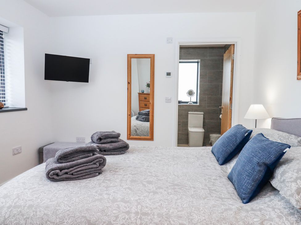 A bedroom with a bed and towels at Lower Moorwood in Moorwood near Bovey Tracey
