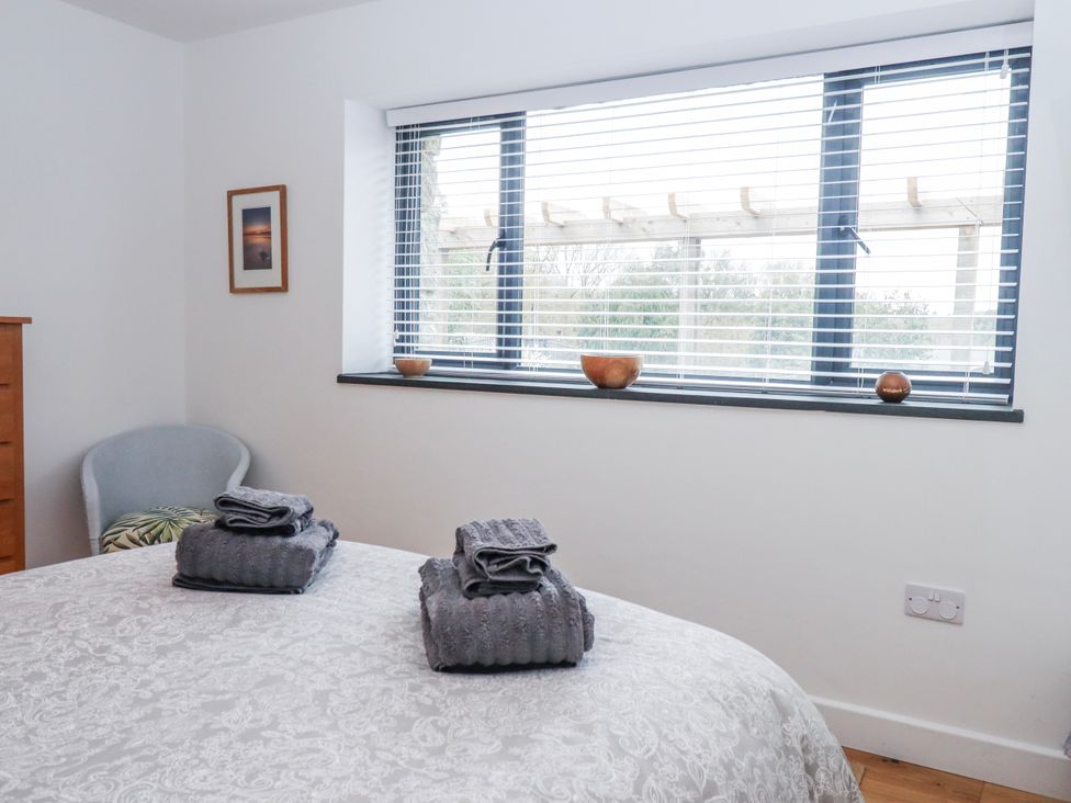 A bedroom with towels on the bed at Lower Moorwood in Moorwood near Bovey Tracey