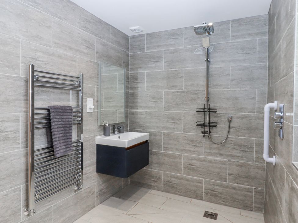 A bathroom with a shower and sink at Lower Moorwood in Moorwood near Bovey Tracey