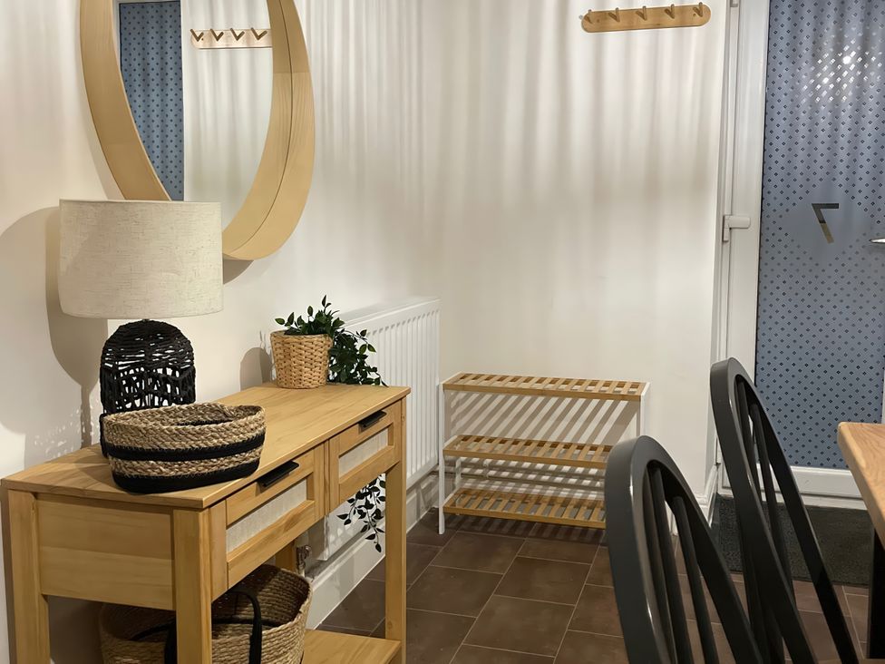 An entryway with a console table and mirror at Plas Darien Apartment 7 Trearddur Bay