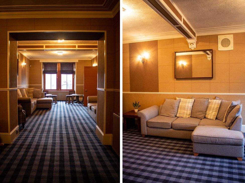 A living room with a sofa and table at Crannoch Self Catering Buckie