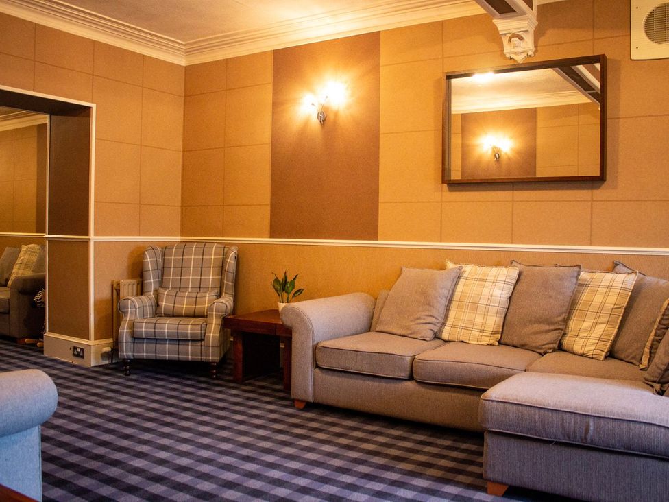 A living room with a sofa and armchair at Crannoch Self Catering in Buckie