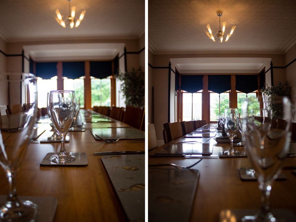 A dining room with a long table and chairs at Crannoch Self Catering in Buckie