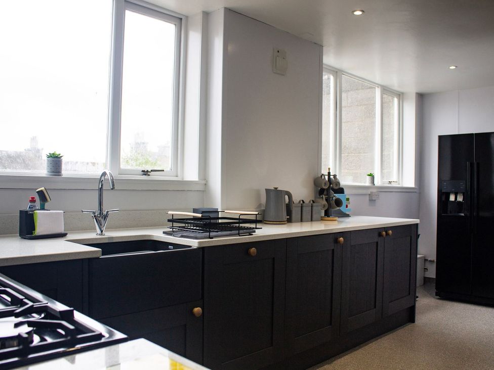 A kitchen with sink, stove, and refrigerator at Crannoch Self Catering Buckie