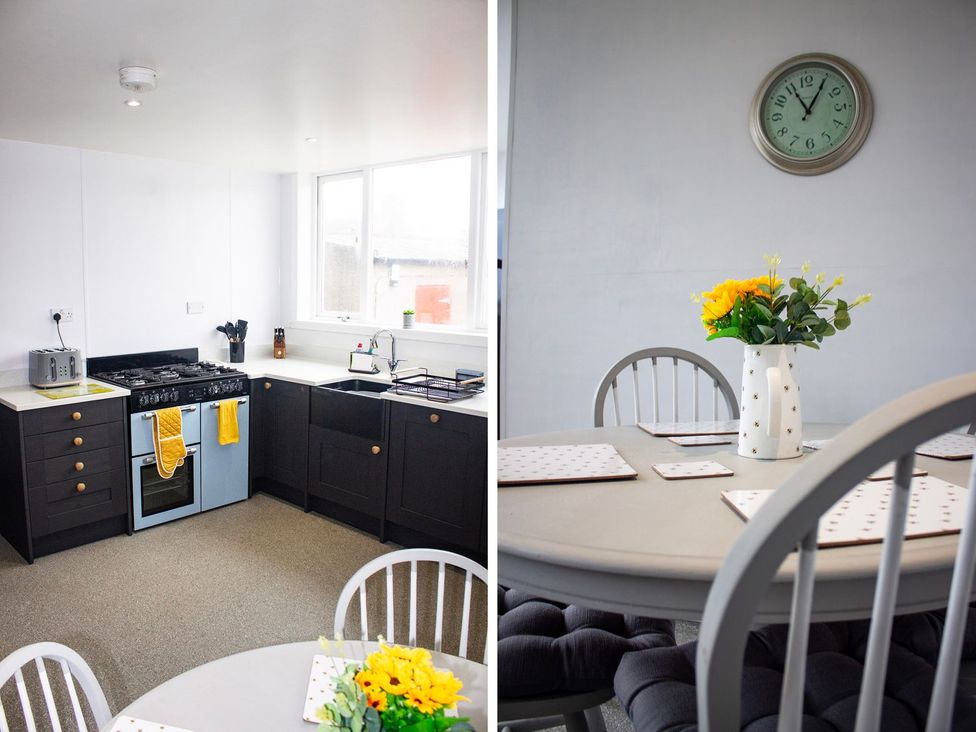 A kitchen with cooking appliances and a dining area at Crannoch Self Catering, Buckie
