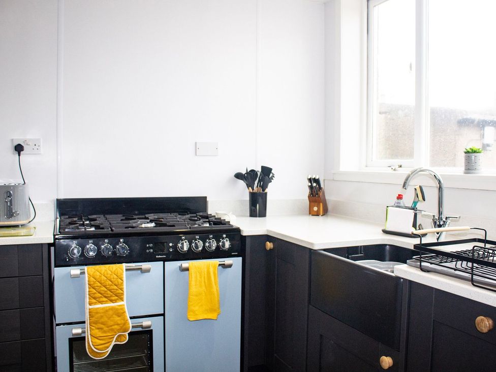 A kitchen with an oven and sink at Crannoch Self Catering Buckie