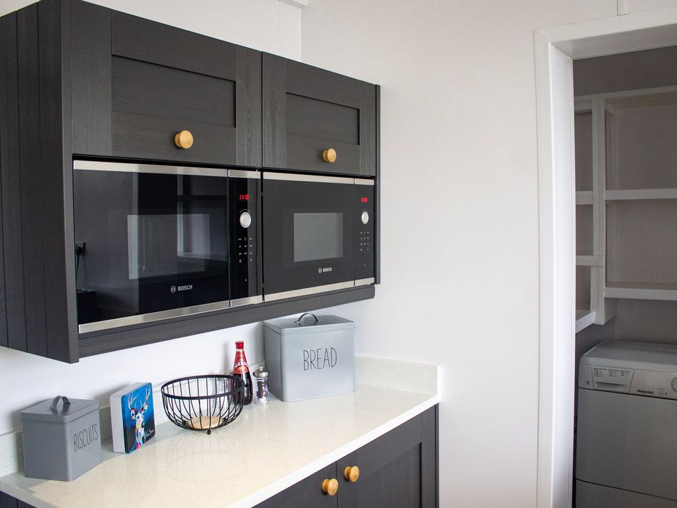 A kitchen with microwave and oven at Crannoch Self Catering in Buckie