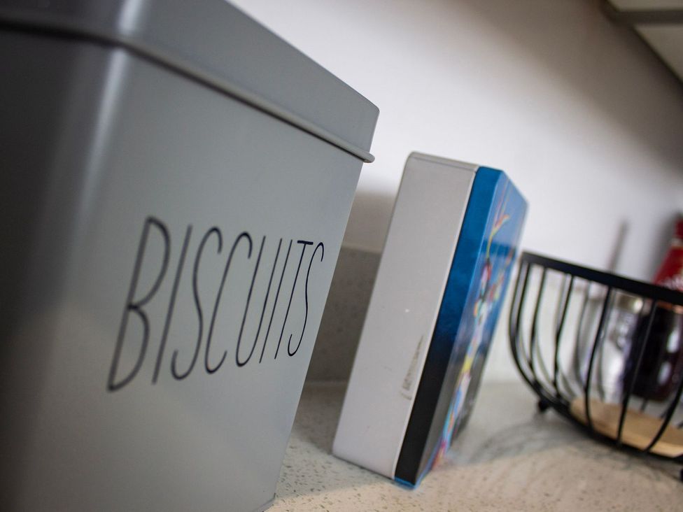 A biscuit tin and a storage box on a countertop at Crannoch Self Catering in Buckie