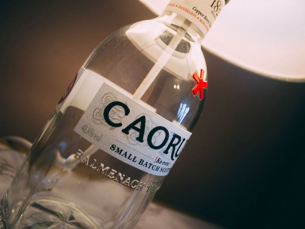 A bottle of Caorunn gin on a surface at Crannoch Self Catering Buckie
