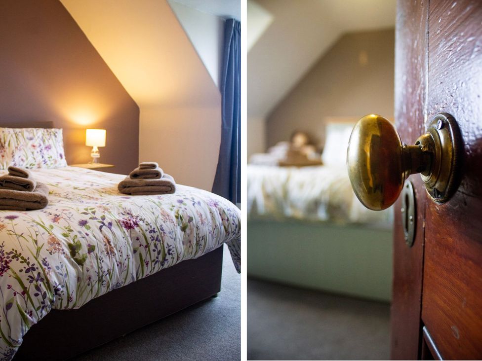 A bedroom with a bed, nightstand, and lamp at Crannoch Self Catering in Buckie