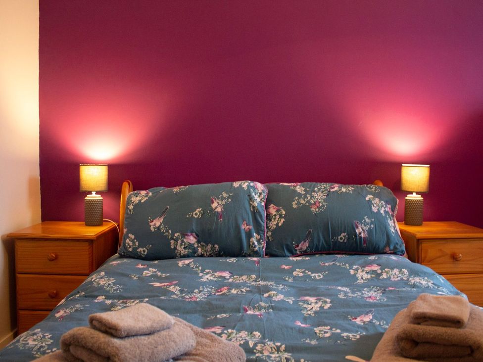 A bedroom with a bed and bedside tables at Crannoch Self Catering, Buckie