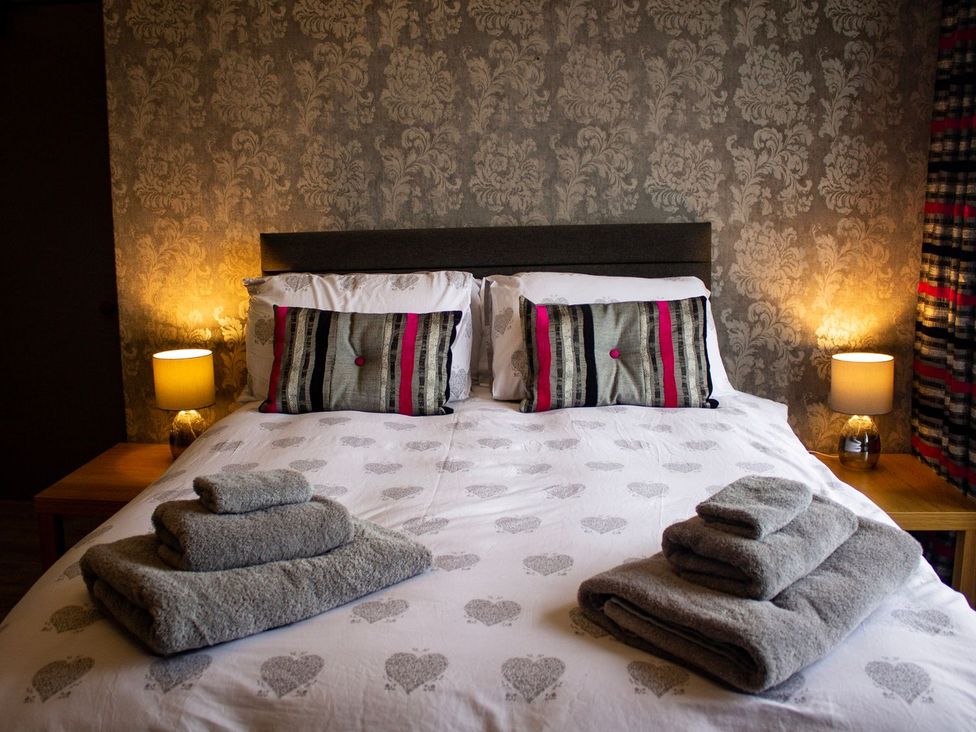 A bedroom with a bed and towels on it at Crannoch Self Catering in Buckie