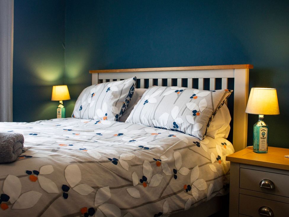 A bedroom with a bed and lamps at Crannoch Self Catering in Buckie