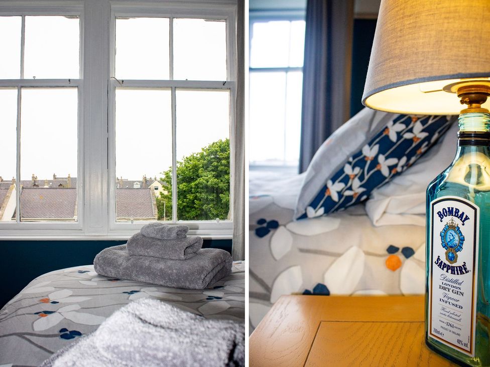 A bedroom with a bed and towels on top at Crannoch Self Catering in Buckie