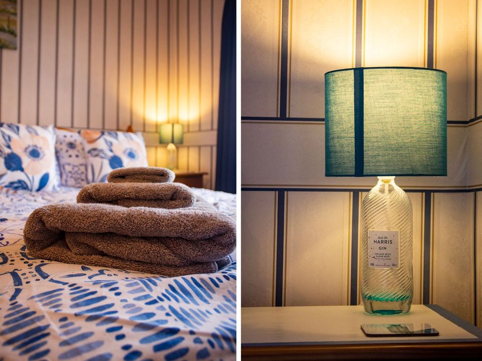 A bedroom with folded towels on a bed at Crannoch Self Catering Buckie