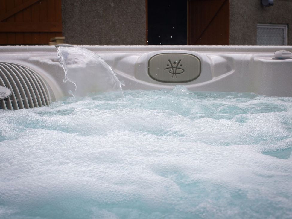 A hot tub with bubbles and water jets at Crannoch Self Catering Buckie