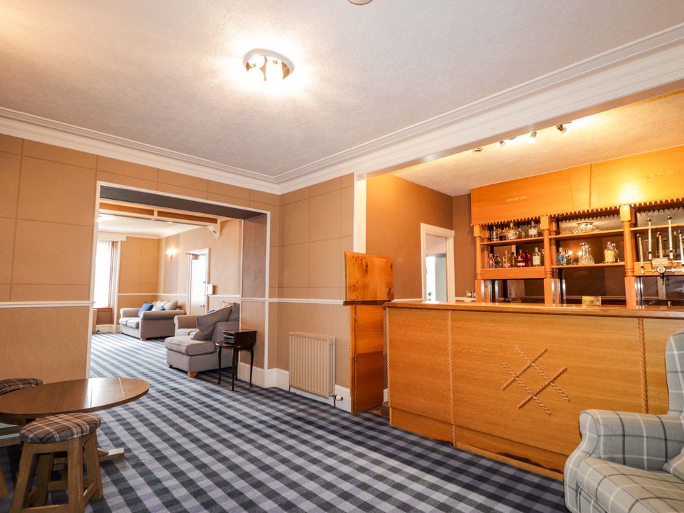 A living room with a bar and seating area at Crannoch Self Catering Cullen