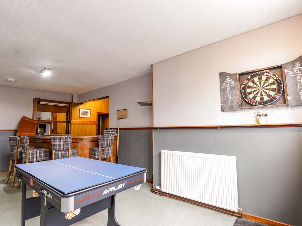 A games room with a ping pong table and a darts board at Crannoch Self Catering in Cullen