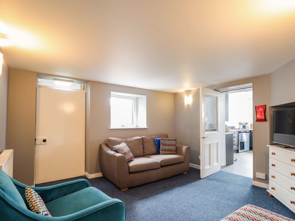 A living room with a sofa and television at Crannoch Self Catering in Cullen