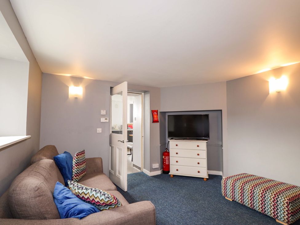 A living room with a sofa and television at Crannoch Self Catering, Cullen