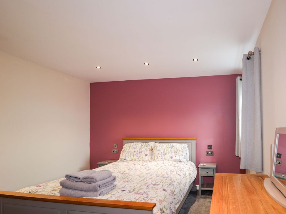 A bedroom with a bed and bedside table at Crannoch Self Catering in Cullen