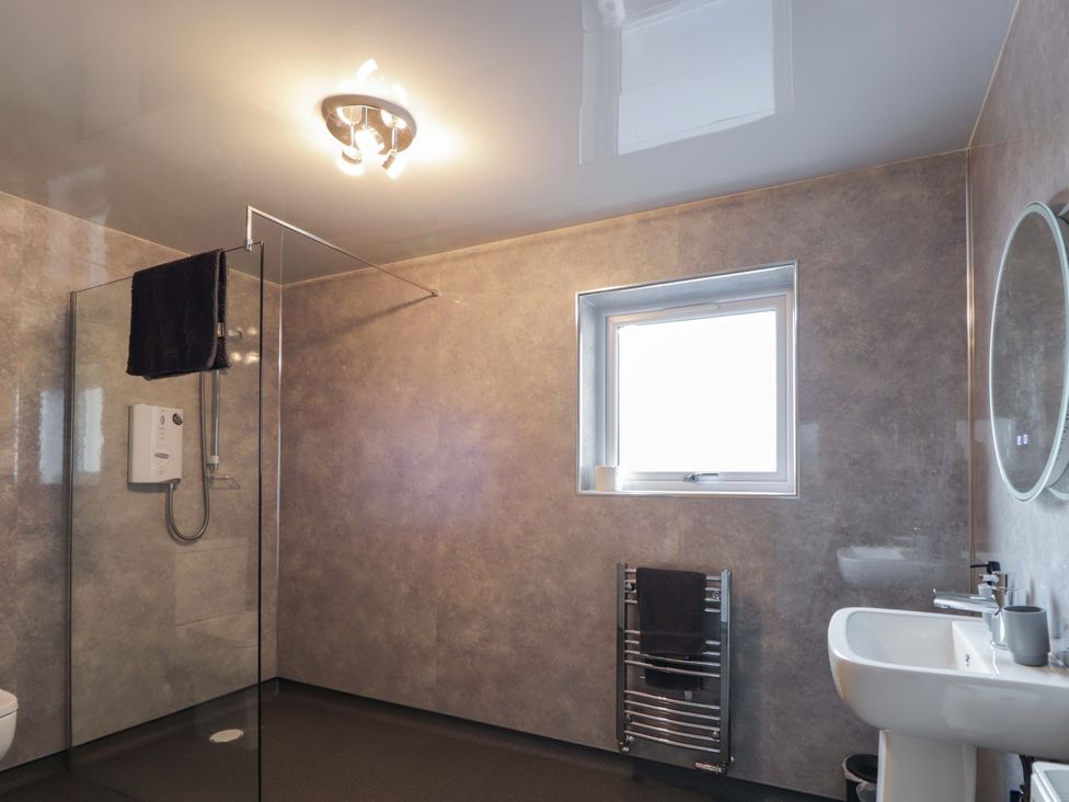A bathroom with a shower and sink at Crannoch Self Catering in Cullen