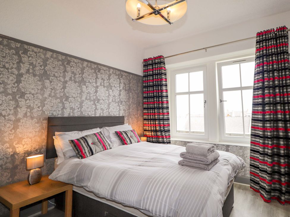 A bedroom with a bed and bedside table at Crannoch Self Catering in Cullen