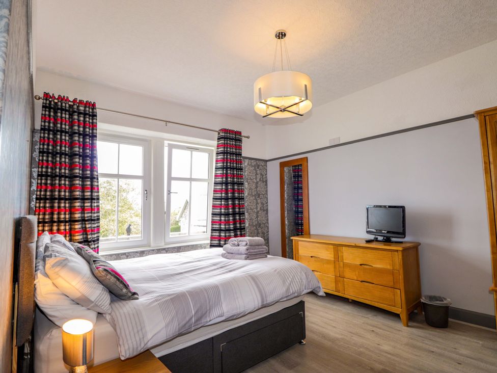 A bedroom with a bed and television at Crannoch Self Catering in Cullen