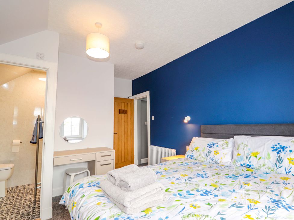A bedroom with a bed and desk at Crannoch Self Catering in Cullen