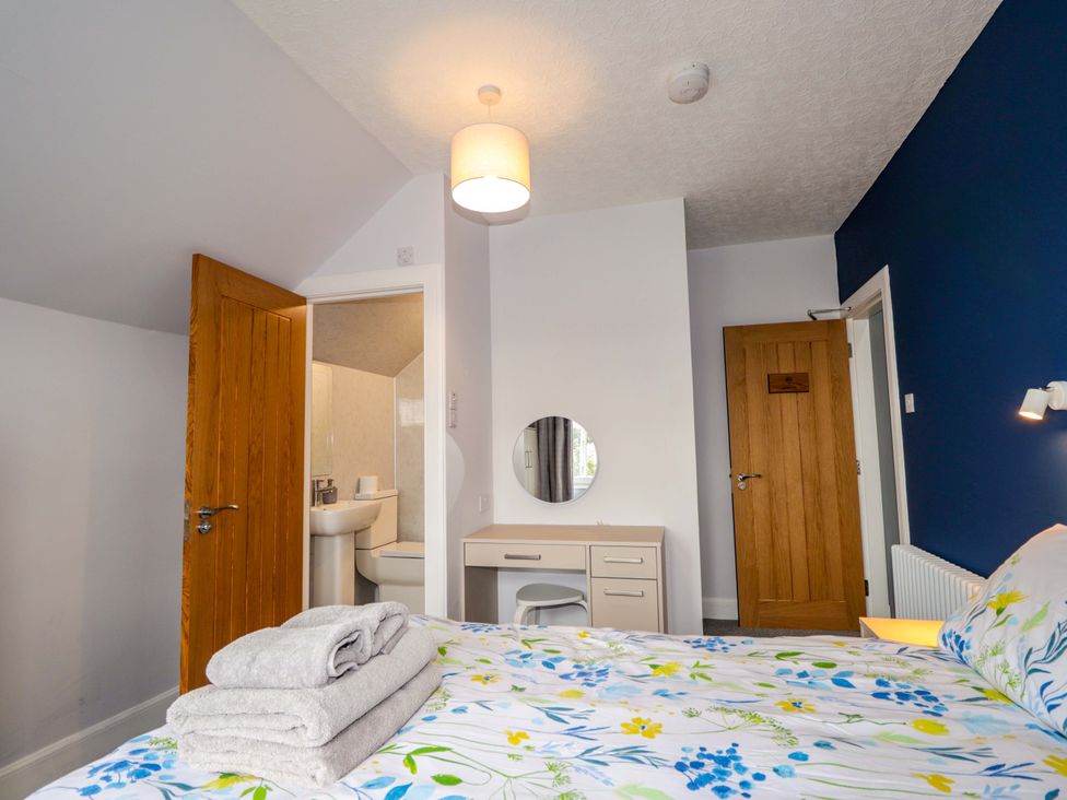 A bedroom with a bed and a desk at Crannoch Self Catering Cullen