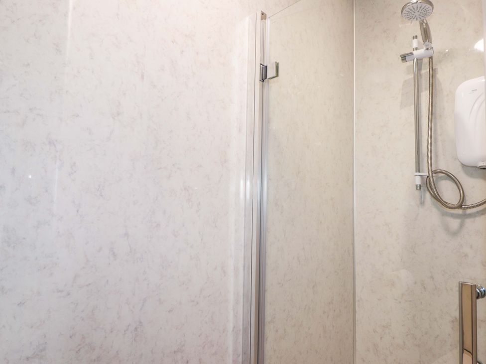 A shower area with a glass door at Crannoch Self Catering in Cullen