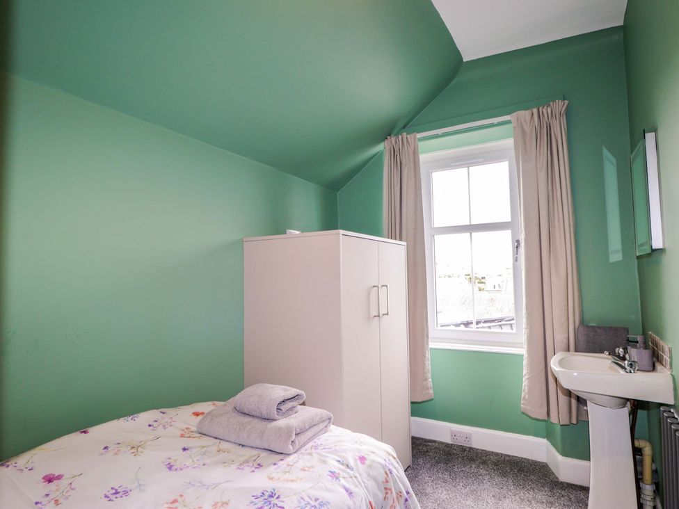 A bedroom with a bed and wardrobe at Crannoch Self Catering in Cullen
