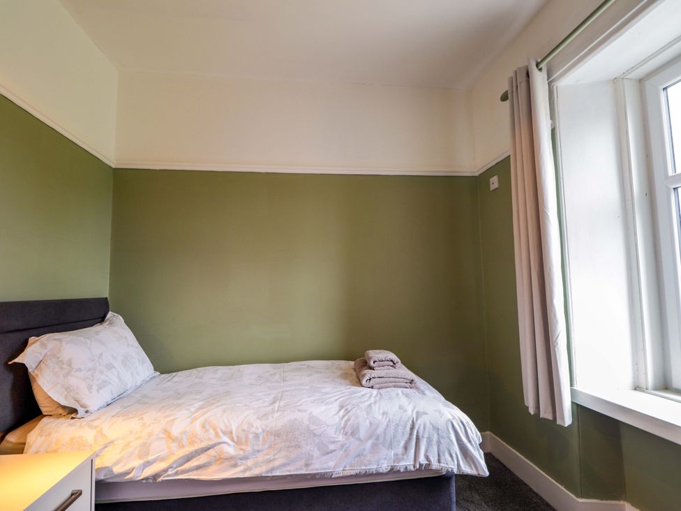 A bedroom with a bed and window at Crannoch Self Catering in Cullen