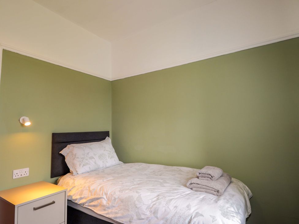 A bedroom with a bed and a bedside table at Crannoch Self Catering in Cullen