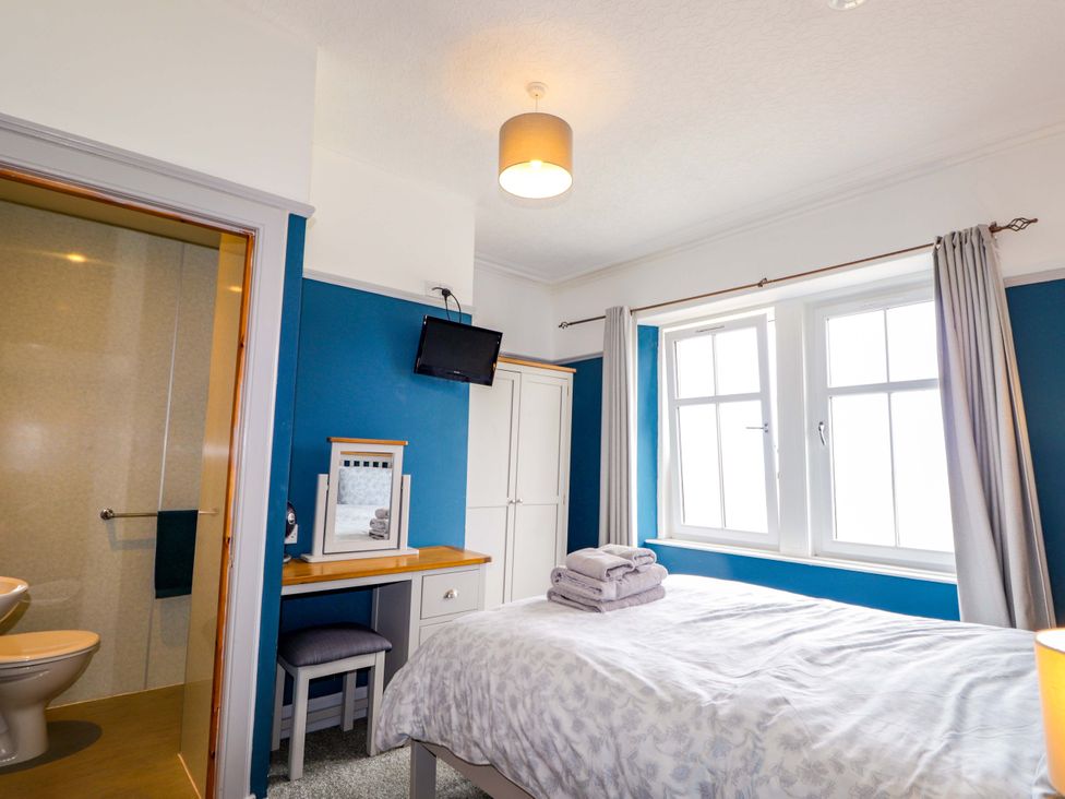 A bedroom with a bed and desk at Crannoch Self Catering Cullen