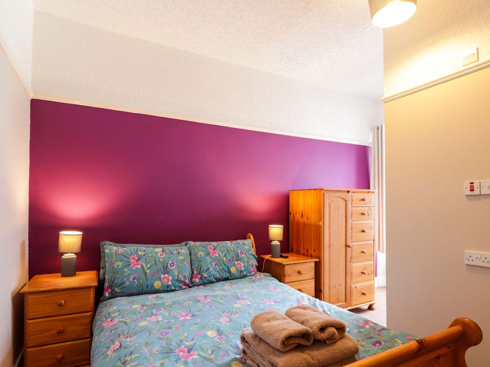 A bedroom with a bed and dresser at Crannoch Self Catering in Cullen