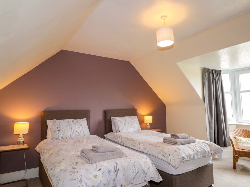 A bedroom with two beds and a lamp at Crannoch Self Catering in Cullen