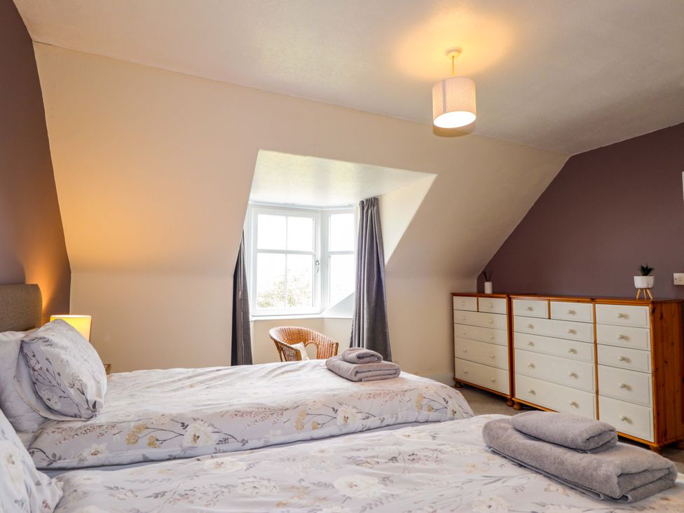 A bedroom with two beds and a window at Crannoch Self Catering in Cullen