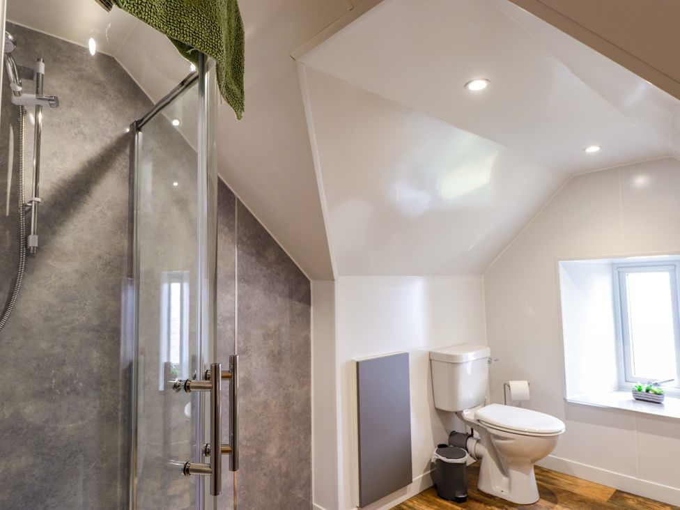A bathroom with a shower and toilet at Crannoch Self Catering in Cullen